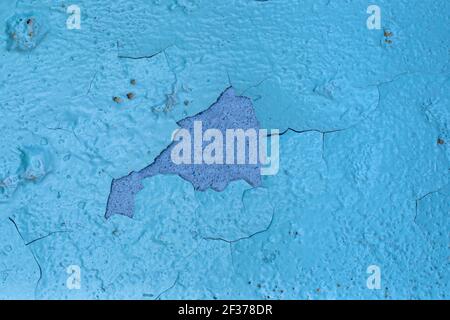 blue background of an old wall painted with oil paint, cracked from old age, with a fallen off paint layer, texture, template for text Stock Photo