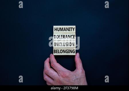 Humanity, tolerance, inclusion, belonging symbol. Wooden blocks with words humanity, tolerance, inclusion, belonging on beautiful black background. To Stock Photo