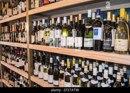 Shelves lined with wine bottles in a downtown shop. Hobe Sound Florida organic wine store, America, USA Stock Photo