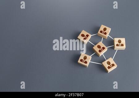 Blocks with businessmen connected by lines into a network team. Participation and assistance in a common project. Communication and feedback. An effic Stock Photo