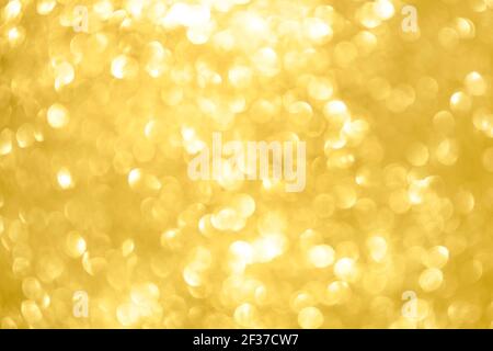 Abstract shiny glitter christmas or new year background. Light Gold glitter background with sparkling texture. Golden shimmering light, sequins sparks Stock Photo