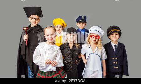 Group of children dressed in costumes of different professions Stock Photo