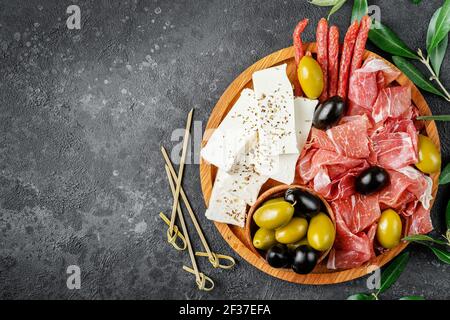 Italian appetizer platter on dark background. Top view, copy space. Stock Photo