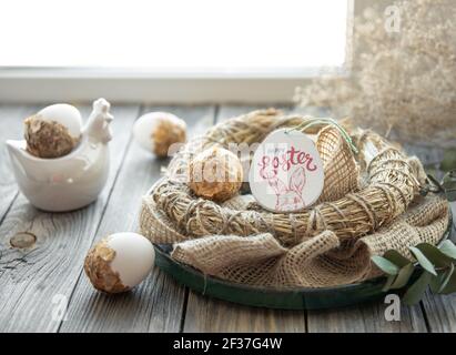 easter composition with festive eggs in a decorative nest. Stock Photo