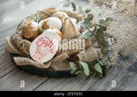 easter composition with festive eggs in a decorative nest close up. Stock Photo