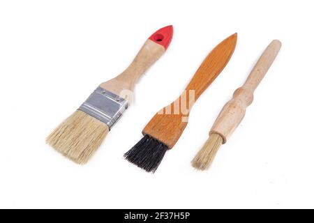 Three different brushes for work in the workshop. Accessories necessary for painting with paints. Light background. Stock Photo