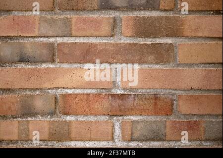 detail of a wall of light and dark brown bricks joined with mortar Stock Photo