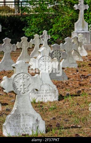 Headstones shaped in the form of Celtic crosses are arranged in a small parish cemetery at Spring Hill College, March 14, 2021, in Mobile, Alabama. Stock Photo