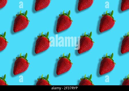 Pattern of strawberries isolated on blue background. Seamless pattern Stock Photo