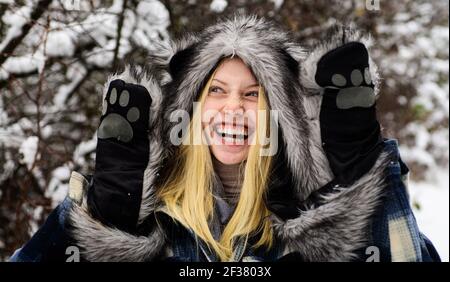 Wintertime. Winter woman in stylish wear. Beautiful female having fun in park. Model girl in warm hat and scarf Stock Photo