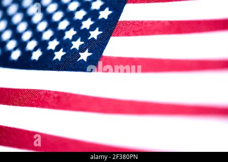 A macro shot with selective focus of a small handheld American flag on coarse fabric. Stock Photo