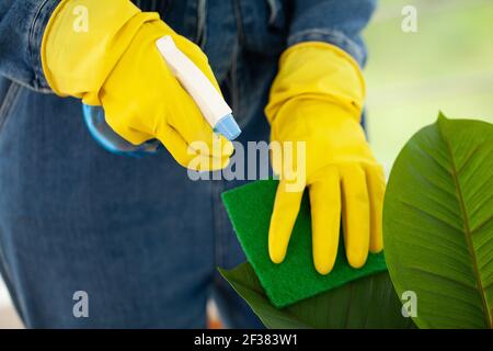 Pretty woman in uniform with supplies cleaning in office Stock Photo