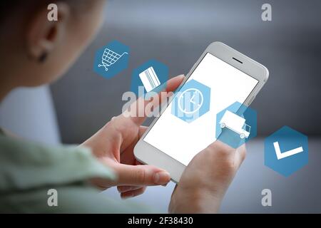 Woman with mobile phone using delivery service application Stock Photo