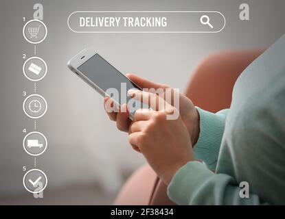 Woman with mobile phone using delivery service application Stock Photo
