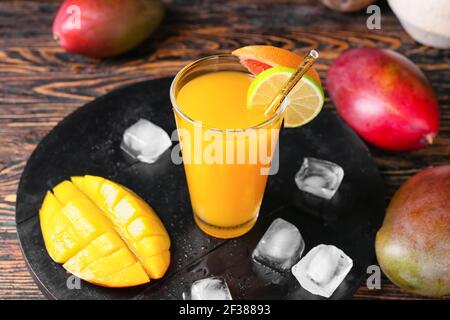 Glass of tasty mango margarita on wooden background Stock Photo