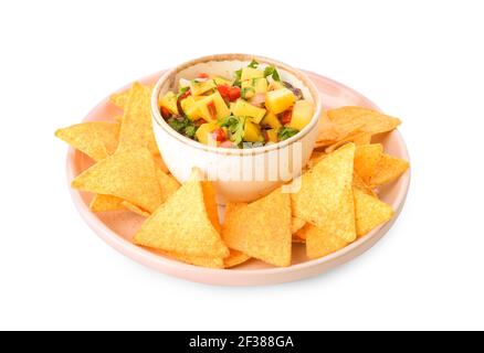 Plate with nachos and fresh mango salsa on white background Stock Photo