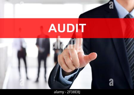 Businessman hand touching AUDIT sign on virtual screen Stock Photo