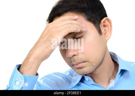 Young Asian man having headache with hand on his forehead Stock Photo