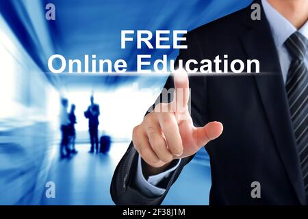 Businessman hand touching FREE Online Education sign virtual screen Stock Photo