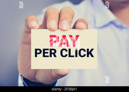 PAY PER CLICK (or PPC) message on the card shown by a man, vintage tone Stock Photo