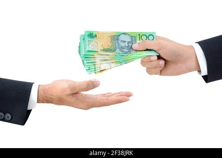 Businessman hands passing money, Australian dollar (AUD) banknotes, isolated on white background Stock Photo