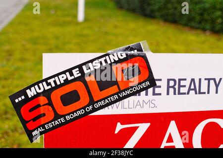 Multiple Listing SOLD sign on the boulevard in front of a residential home that was sold. Real Estate Board of Greater Vancouver. Stock Photo