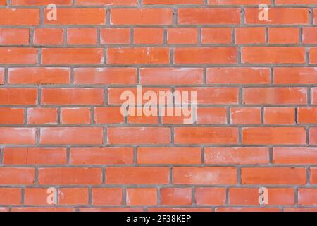 Red brick brick wall.Brick wall background with cement stains Stock Photo