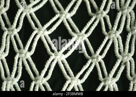 This art macrame craft made of crocheted rope for interior home decoration. Stock Photo