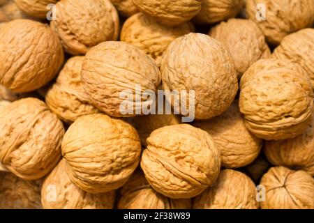 Natural walnut in shells background pattern texture Abstract closeup with blurred edges Stock Photo