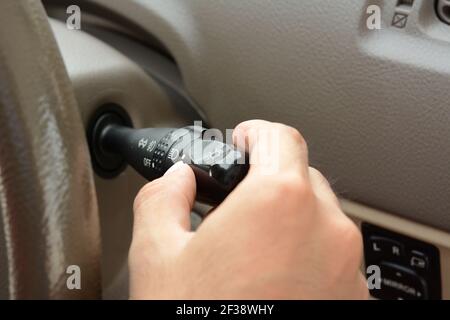 Hand adjusting car headlight control switch Stock Photo