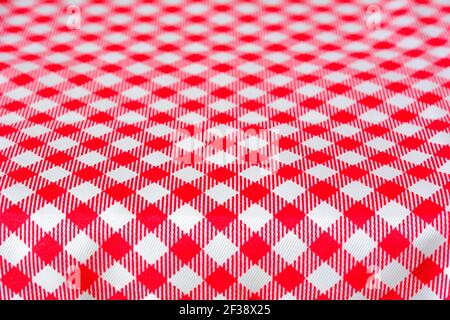 Table covered with red checkered picnic tablecloth - can be used as background for montage food and products Stock Photo