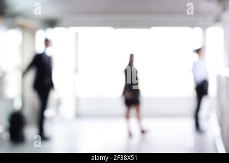 Blurred business people standing in building hall , can be used as abstract background Stock Photo