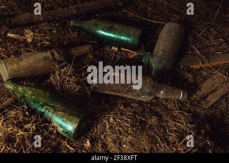 dusty bottles on the floor in an abandoned house Stock Photo