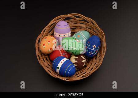 basket of twigs with Easter eggs on black Stock Photo