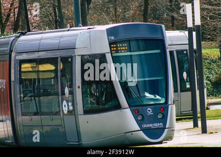 Reims France March 15, 2021 Modern electric tram for passengers rolling through the streets of Reims during the coronavirus outbreak hitting France Stock Photo