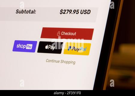 Shop Pay by Shopify, Apple Pay and PayPal payment options are seen on an online store's checkout page on a laptop computer. Stock Photo