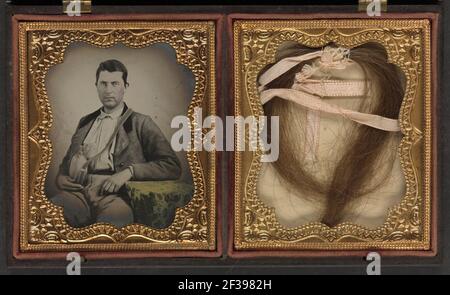 Private James W. McCulloch of Co. E, 7th Georgia Infantry Regiment holding wooden canteen, with lock of hair, obituary, and poem in case Stock Photo