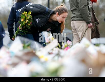 London, UK. 15th Mar, 2021. A woman lays floral tributes at the bandstand on Clapham Common to mourn for Sarah Everard in London, Britain, on March 15, 2021. A serving Metropolitan police officer on March 13 appeared in court in London after being charged with the kidnap and murder of a 33-year-old woman. Wayne Couzens, 48, was arrested after Sarah Everard, a marketing executive, went missing while walking home from a friend's apartment in south London on March 3. Credit: Xinhua/Alamy Live News