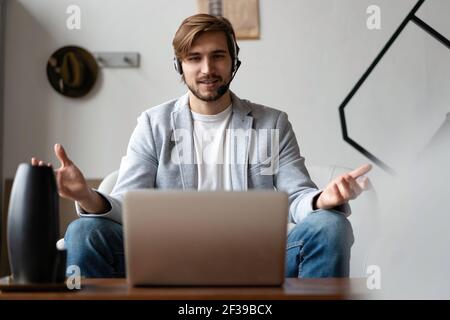 Male remote working from home and having work confrence video call. Stock Photo