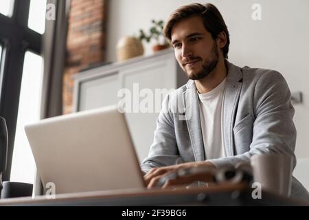 Male remote working from home and having work confrence video call. Stock Photo