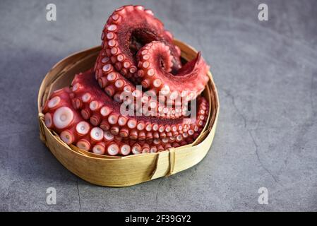 Boiled octopus tentacles on wooden tray, Octopus food cooked seafood squid cuttlefish dinner restaurant Stock Photo