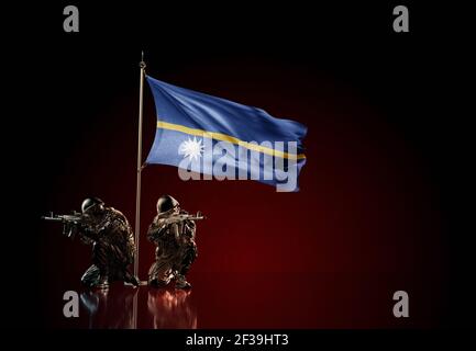 Concept of military conflict with soldier statues and waving national flag of Nauru. Illustration of coup idea. Two guards defending the symbol Stock Photo
