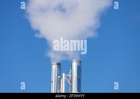 White smoke comes from the silver chimney. High quality photo Stock Photo