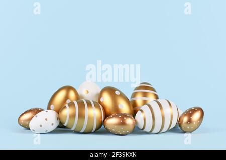Elegant golden and white Easter eggs painted with simple dots and stripes on blue background Stock Photo