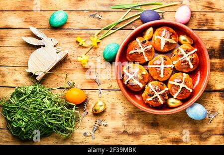 Easter hot cross buns and holiday decor.Traditional English Easter buns. Stock Photo