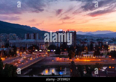 Elevated view of traffic on bridge passing over Vardar River with Skopje cityscape in background Stock Photo