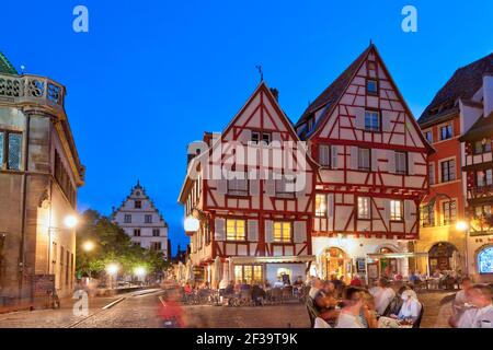 Colmar (north-eastern France): facades of half-timbered houses, Alsatian traditional houses in the town center, evening, at the corner of the streets Stock Photo