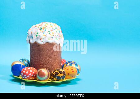 Paska Easter cake and painted eggs of pysanka on a blue background with place for text copy space. Traditional holiday photo. Stock Photo