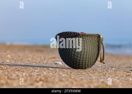 World War II American helmet on a beach of the Normandy landings Stock Photo