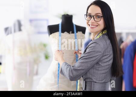 Portrait of young woman seamstress in wedding salon Stock Photo